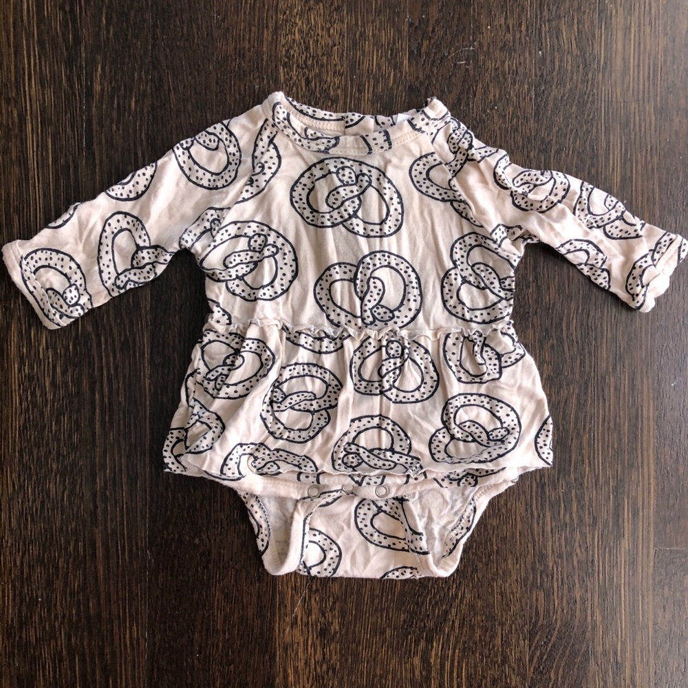 Pretzel pattern skirted onesie